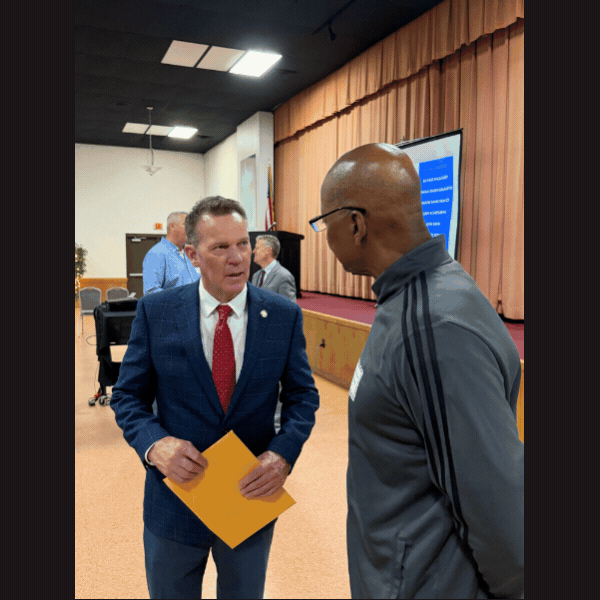 Slideshow of images of Sen. Laughlin talking with veterans, and standing alongside podium, and an image of attendees seated for the Veterans Breakfast