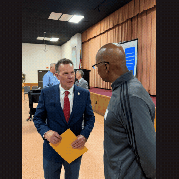 Slideshow of images of Sen. Laughlin talking with veterans, and standing alongside podium, and an image of attendees seated for the Veterans Breakfast