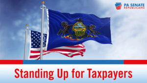 American flag flying behind PA flag with the words Standing Up for Taxpayers underneath.