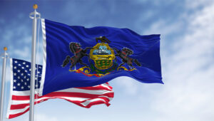 State Budget: United States and Pennsylvania flags on flagpoles