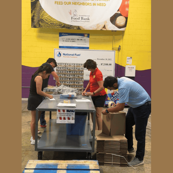 Slideshow of Photos of Staff Packing Cans into Boxes
